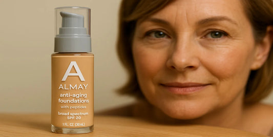 A bottle of Almay anti-aging foundation stands on a wooden surface with a middle-aged woman smiling softly in the background, showcasing healthy skin.