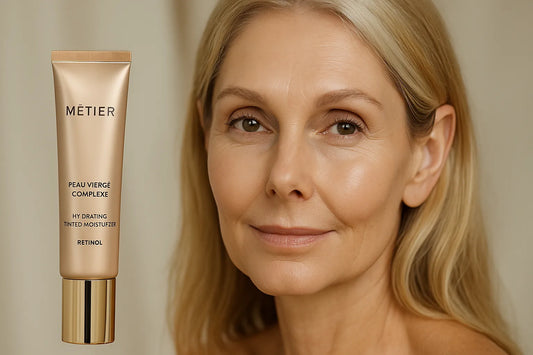 A middle-aged woman with glowing skin next to a MĒTIER Peau Vierge Complexe retinol moisturizer, showcasing natural radiance and elegance.